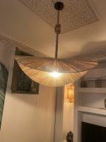 Asymmetric raffia pendant light with handmade curved canopy shade