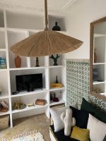 Asymmetric raffia pendant light with handmade curved canopy shade