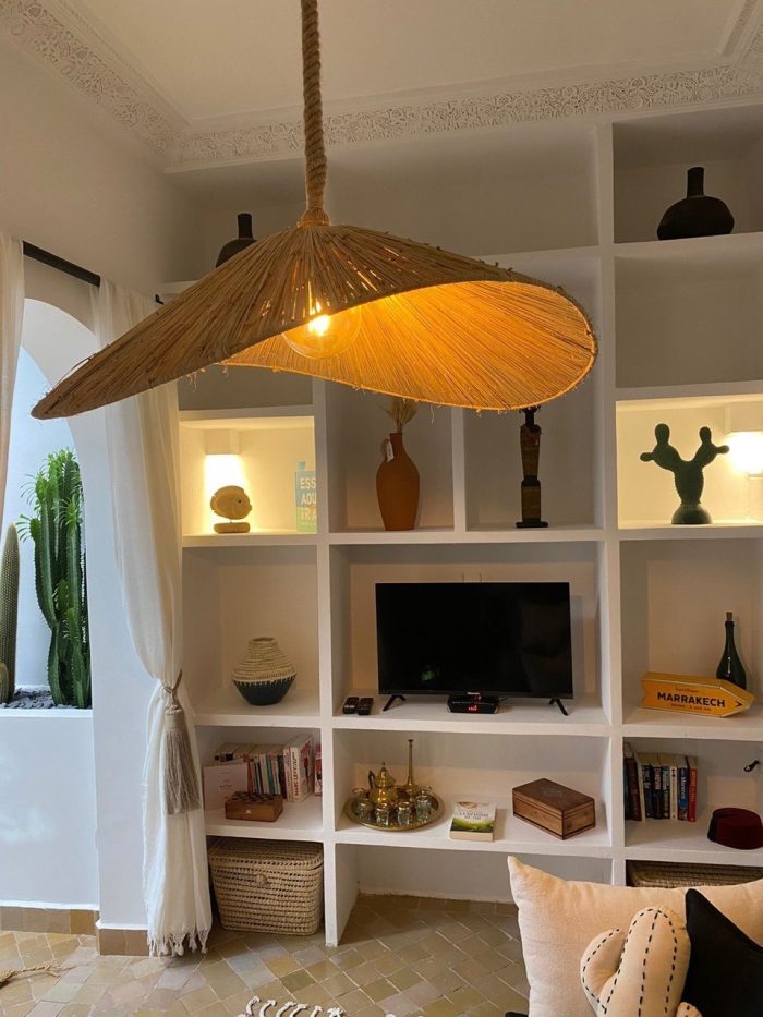 Asymmetric raffia pendant light with handmade curved canopy shade
