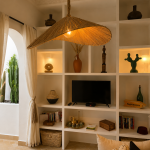 Asymmetric raffia pendant light with handmade curved canopy shade