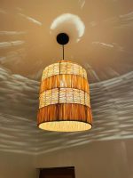 Tiered raffia pendant light with handwoven bell shaped shade