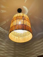 Tiered raffia pendant light with handwoven bell shaped shade