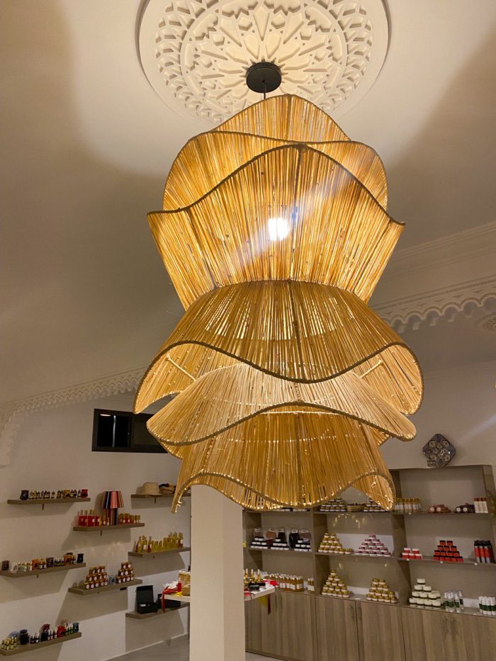 Spiral raffia pendant light with cascading handwoven layers