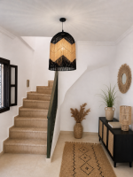 Black and natural bell raffia pendant light with geometric woven design