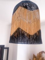 Black and natural bell raffia pendant light with geometric woven design