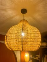 Sculptural raffia pendant light with rounded handmade Moroccan woven shade