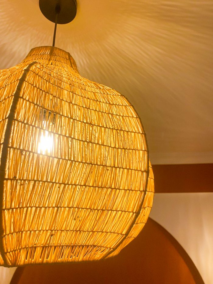Sculptural raffia pendant light with rounded handmade Moroccan woven shade
