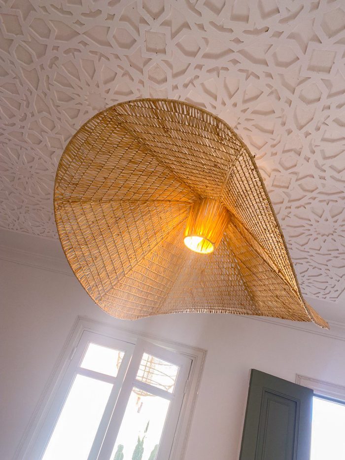 Handmade wavy raffia pendant light with sculptural woven dome shape