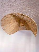 Handmade wavy raffia pendant light with sculptural woven dome shape
