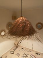 Natural Doum Straw Fringe Pendant Light handmade from woven straw and doum fibers with long flowing fringe.