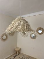 Natural Doum Straw Fringe Pendant Light handmade from woven straw and doum fibers with long flowing fringe.