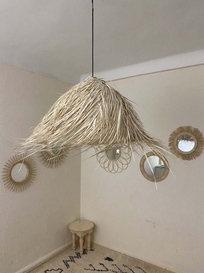 Natural Doum Straw Fringe Pendant Light handmade from woven straw and doum fibers with long flowing fringe.