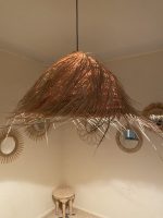 Natural Doum Straw Fringe Pendant Light handmade from woven straw and doum fibers with long flowing fringe.