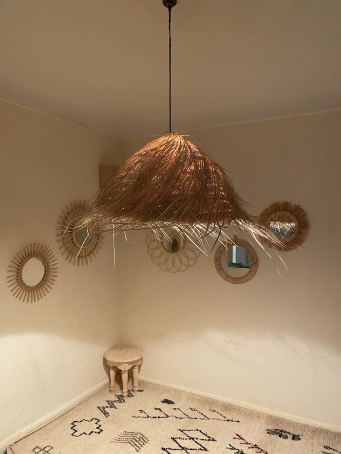 Natural Doum Straw Fringe Pendant Light handmade from woven straw and doum fibers with long flowing fringe.