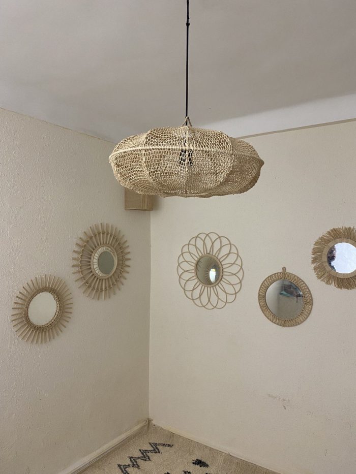 Sculptural Raffia Pendant Light handmade from natural woven raffia with a structured metal frame.