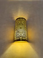 Handmade Moroccan brass wall sconce crafted from solid brass with intricate pierced detailing and warm up-and-down decorative illumination.