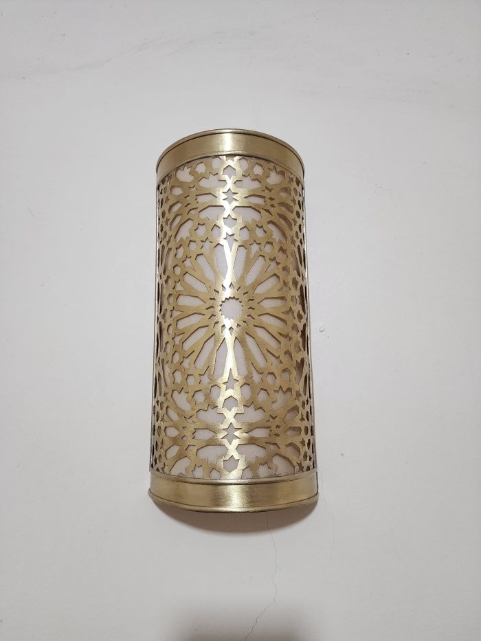 Handmade Moroccan rosette brass wall sconce with pierced floral pattern and warm ambient lighting.