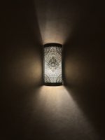 Handmade diamond medallion brass wall sconce with intricate perforated pattern and warm decorative up-and-down lighting.