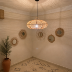 Sculptural Raffia Pendant Light handmade from natural woven raffia with a structured metal frame.