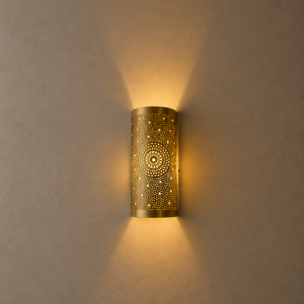 Handmade sunburst brass wall sconce with circular pierced medallion and warm up and down ambient lighting.