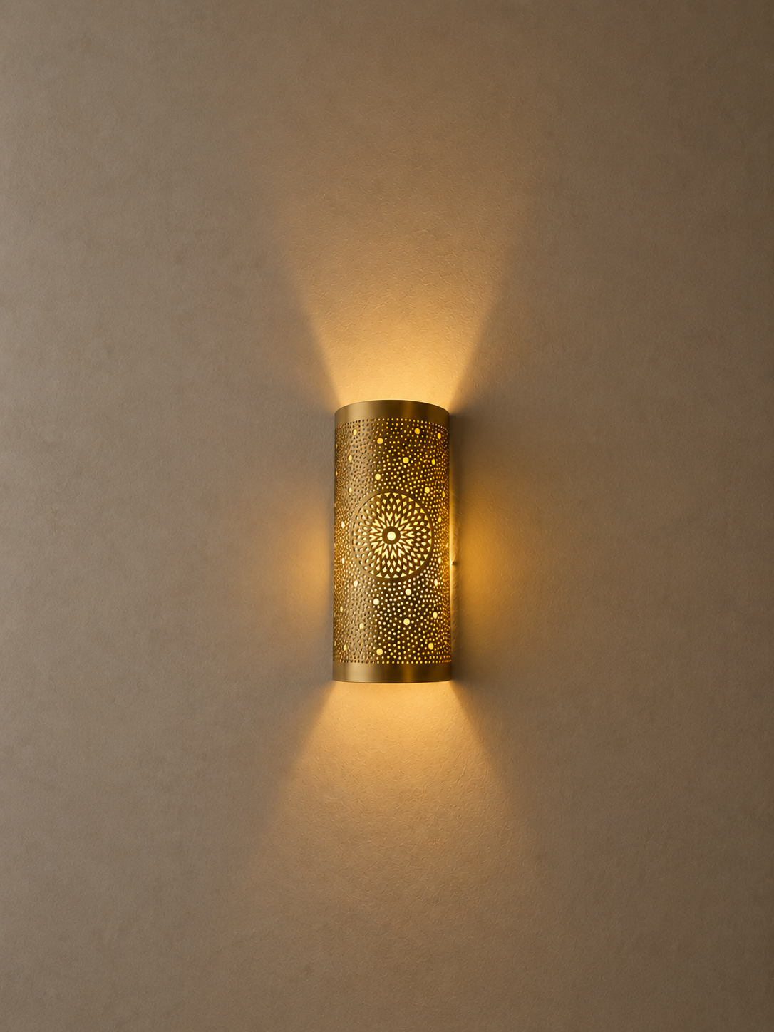 ChatGPT Image 26 août 2026, 23_30_32 Handmade sunburst brass wall sconce with circular pierced medallion and warm up and down ambient lighting.