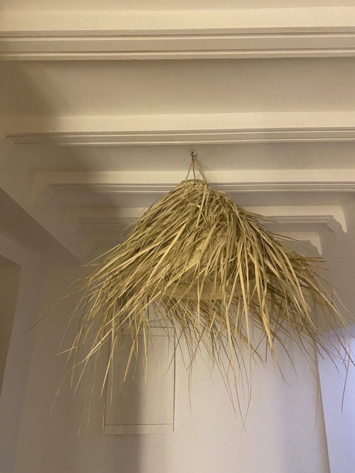 Natural Doum Straw Fringe Pendant Light handmade from woven straw and doum fibers with long flowing fringe.