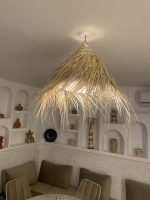 Natural Doum Straw Fringe Pendant Light handmade from woven straw and doum fibers with long flowing fringe.
