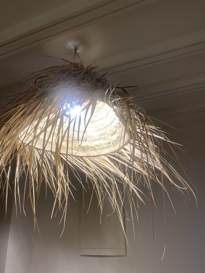 Natural Doum Straw Fringe Pendant Light handmade from woven straw and doum fibers with long flowing fringe.