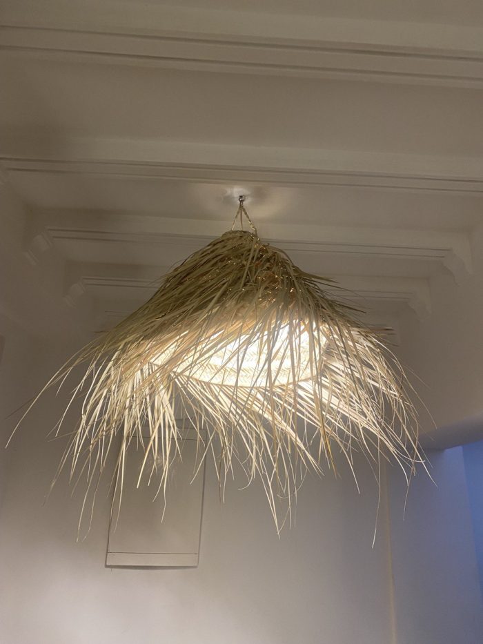 Natural Doum Straw Fringe Pendant Light handmade from woven straw and doum fibers with long flowing fringe.
