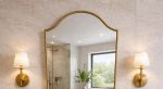 Handmade Curved Shield Brass Mirror with brass frame above wooden bathroom vanity