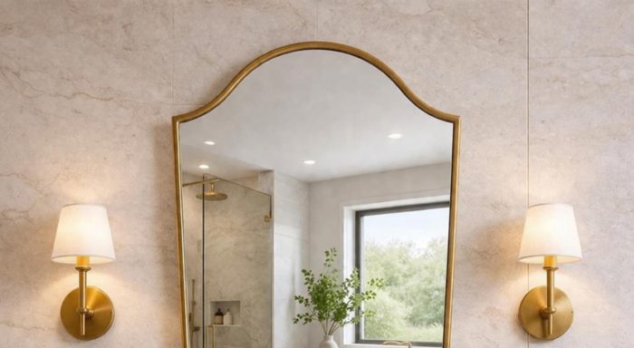 Handmade Curved Shield Brass Mirror with brass frame above wooden bathroom vanity