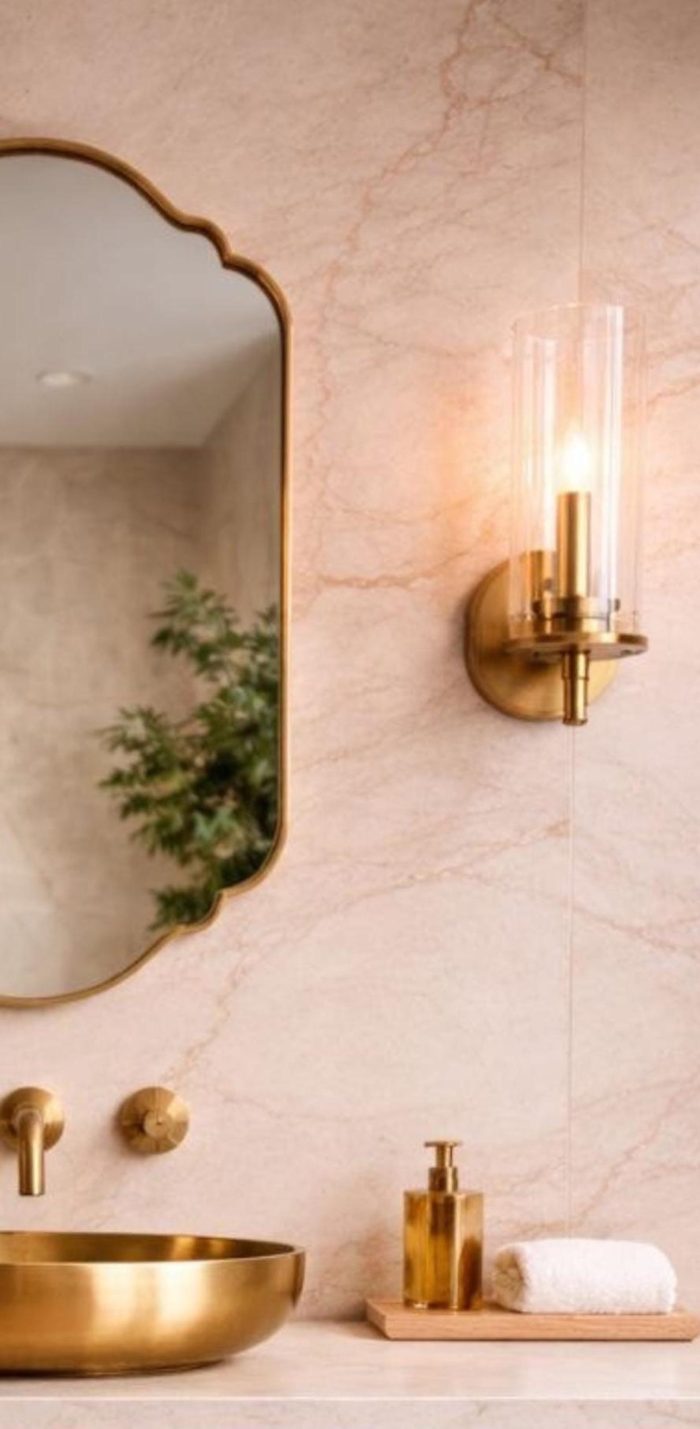 Scalloped Arch Brass Mirror above brass vessel sink and green tiled bathroom wall
