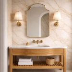 Crown Top Brass Mirror above wood bathroom vanity with brass fixtures