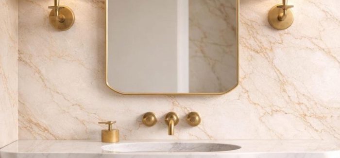 Crown Top Brass Mirror above wood bathroom vanity with brass fixtures