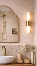 Handmade crown arch brass wall mirror with curved shoulders and slim gold brass frame above a bathroom vanity.
