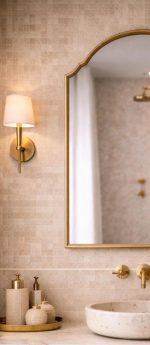 Arched Brass Mirror with curved brass frame above a bathroom vanity