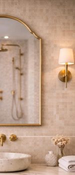 Arched Brass Mirror with curved brass frame above a bathroom vanity