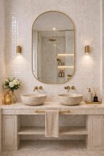 Handmade rounded arch brass wall mirror with solid brass frame above a double bathroom vanity.