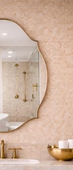 Handmade curved crown brass wall mirror with scalloped edges and solid brass frame above bathroom vanity.