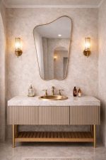 Organic Brass Mirror with irregular asymmetrical frame above a bathroom vanity