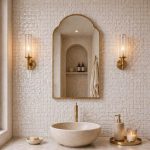 Handmade Arched Brass Vanity Mirror styled with brass sconces and bathroom vanity