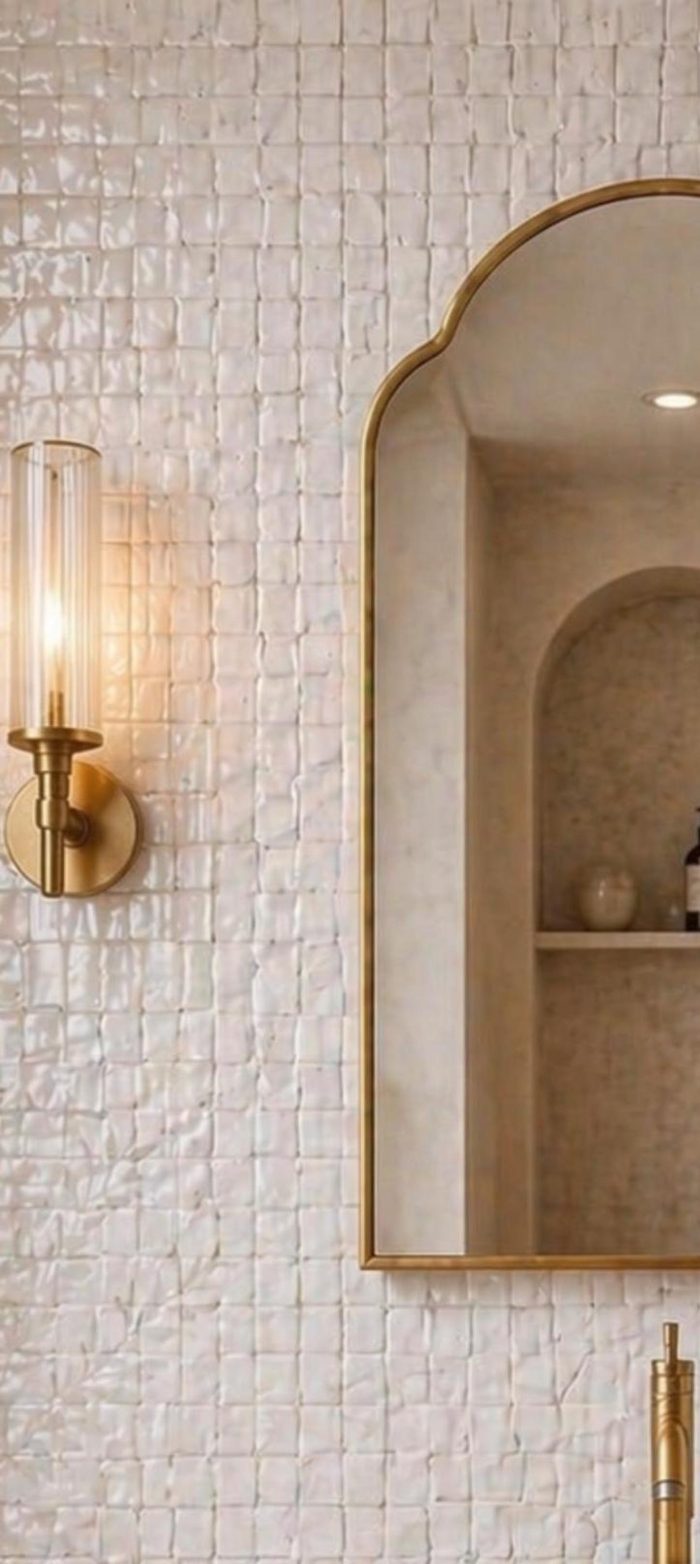 Handmade Arched Brass Vanity Mirror styled with brass sconces and bathroom vanity