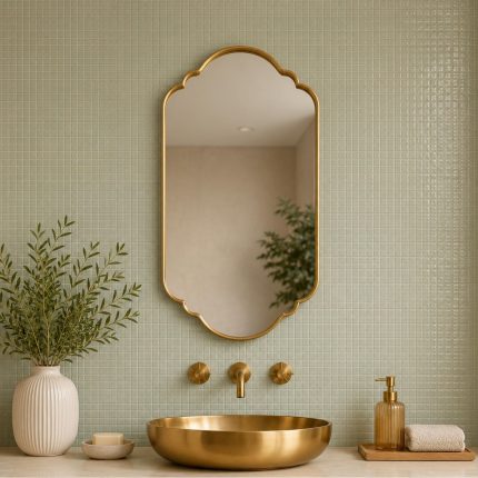 Scalloped Arch Brass Mirror above brass vessel sink and green tiled bathroom wall