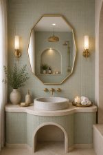 Handmade octagonal brass wall mirror with elongated geometric shape and solid brass frame above bathroom vanity.