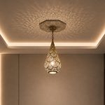 Teardrop Moroccan Brass Pendant Light handmade pierced brass hanging lamp casting decorative ceiling shadows