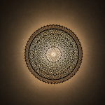 Round Filigree Brass Wall Light with intricate hand-perforated brass design
