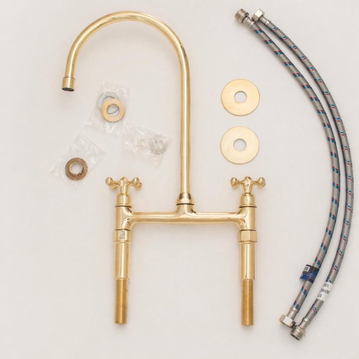 Antique brass bridge faucet with high arc gooseneck spout, cross handles and side sprayer